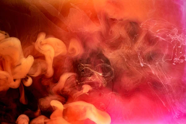 黒インクの背景にオレンジピンクの煙 カラフルな霧 抽象的な渦巻くタッチ海 アクリル絵具の顔料水中 — ストック写真