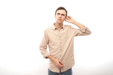 Uyanık, esmer bir adam kafasında şüphe uyandırıyor, kararlarını mavi stüdyonun arka planında yalnız bırakıyor.