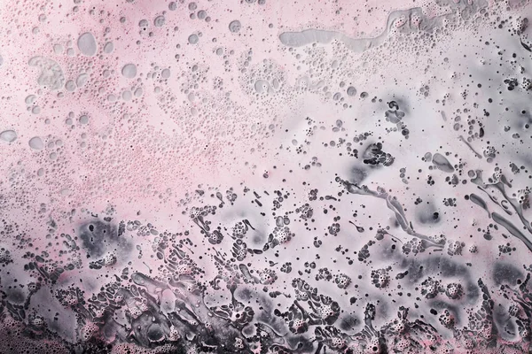 Ink abstract background, paint bubbles pattern underwater, light pink acrylic pigment