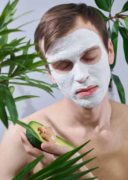 Portrait Young Handsome Man Cosmetic Mask His Face Holding Avocado — Stock Photo, Image