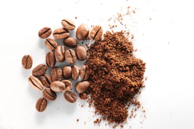 Kavrulmuş kahve çekirdekleri farklı türde öğütülmüş ve tamamen izole edilmiş. Beyaz arka planda.