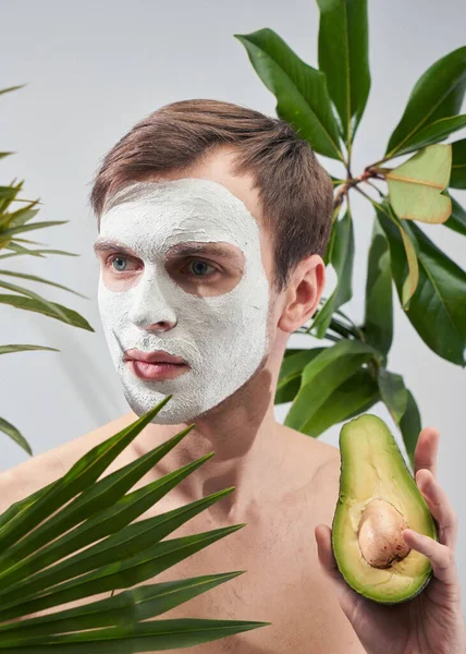 Portrait Young Handsome Man Cosmetic Mask His Face Holding Avocado — Stock Photo, Image