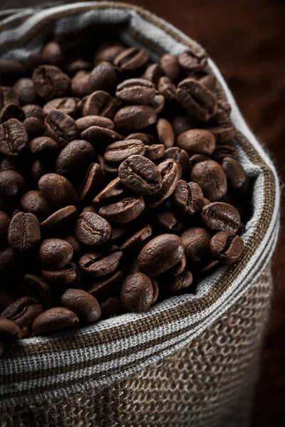 Roasted coffee beans in a bag closeup background