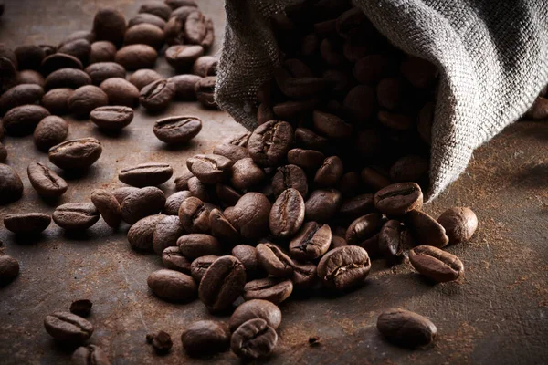 Roasted coffee beans in a bag closeup background