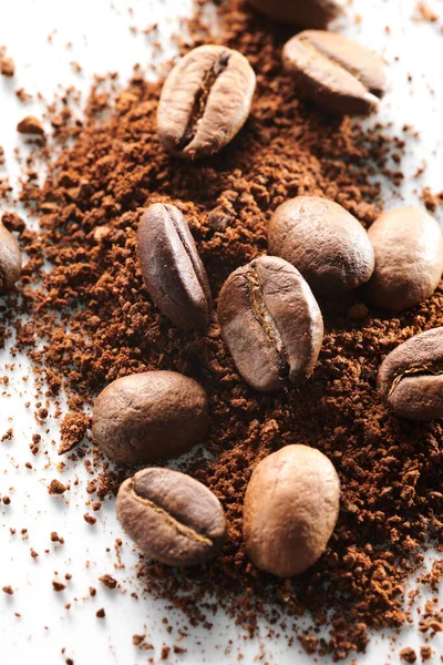 Roasted coffee beans different sort ground and whole isolated close up on white background