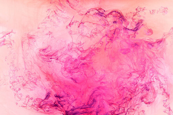 Liquid fluid art abstract background. Pink dancing acrylic paints underwater, ocean space smoke