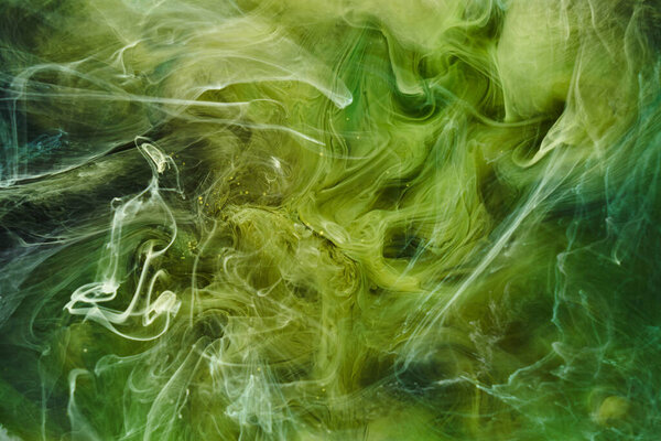 Liquid fluid art abstract background. Green dancing acrylic paints underwater, cosmic smoke ocean