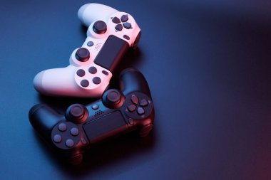 Oyun konsolu için siyah arka planda izole edilmiş iki oyun kumandası, joystick. Oyuncu kontrol cihazları yakın plan