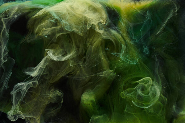 Liquid fluid art abstract background. Green dancing acrylic paints underwater, cosmic smoke ocean