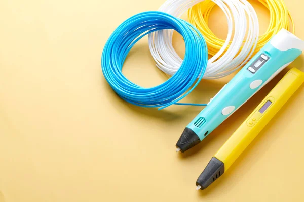 3d pen for creating volume plastic figures isolated on yellow background