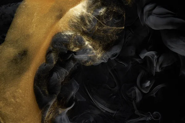 Golden sparkling abstract background, luxury black smoke, acrylic paint underwater explosion, cosmic swirling ink