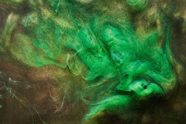 Golden sparkling abstract background, luxury green smoke, acrylic paint underwater explosion, cosmic swirling ink