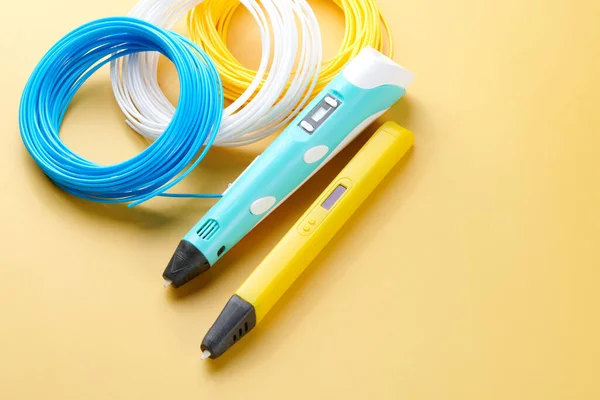 3d pen for creating volume plastic figures isolated on yellow background