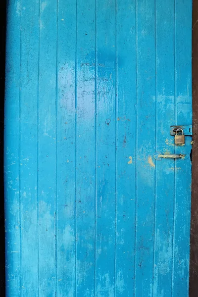 Old rustic wooden doors painted in blue.