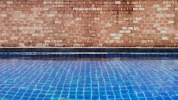 Old red brick wall texture with swimming pool
