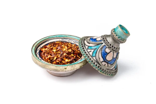 Red chilli pepper flakes in a mini Moroccan tagine