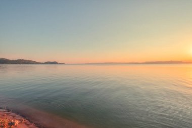On the shore of the lake in the late afternoon