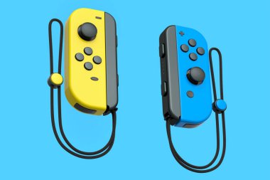 Mavi arka planda ipte taşınabilir sarı oyun kontrolörleri var. Çevrimiçi oyun için akıllı telefon için 3B oyun alanı oluşturma