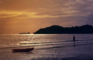 Batımını sahilde duran kadın