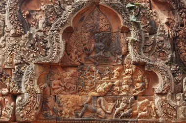 Close up of  Pediment shows Shiva seated on the summit of Mount Kailash, his mythological abode. His consort Uma Devi sits on his lap and clings anxiously to his torso at at Banteay Srei Temple