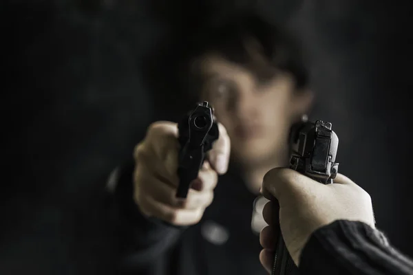 Mans hand with pistol pointed at criminal with revolver. — Stock Photo, Image