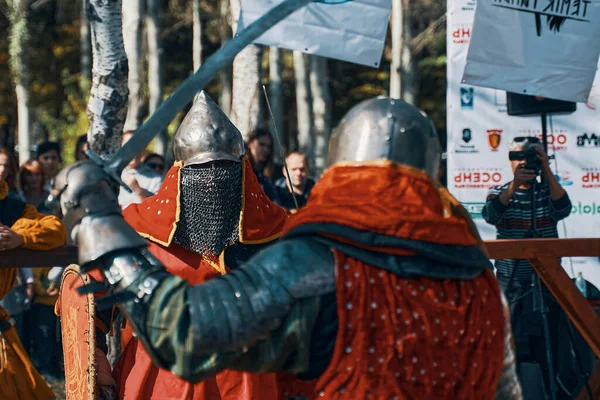Zwei rotgewandete Ritter kämpfen mit Schwertern. — Stockfoto