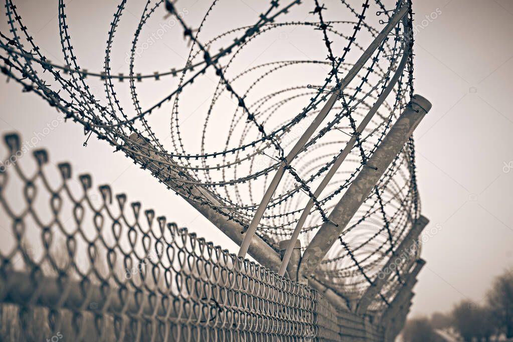 Prison fence. Barbed wire.