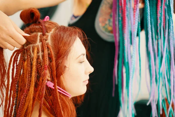 Hairdresser weaves braids with kanekalon to young girl head. — Stock Photo, Image