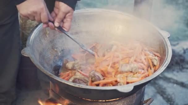 Man Mixes Meat Vegetables Oil Slotted Spoon Large Cauldron Delicious — Vídeos de Stock
