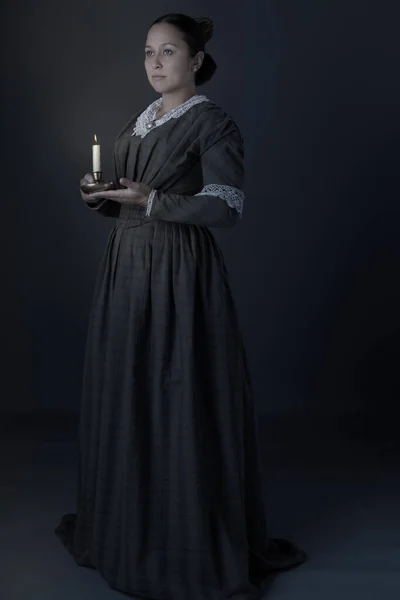 Victorian Working Class Woman Standing Alone Holding Candle Dark — Stock fotografie