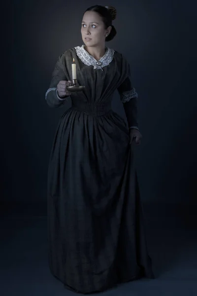 Victorian Working Class Woman Standing Alone Holding Candle Dark — Fotografia de Stock
