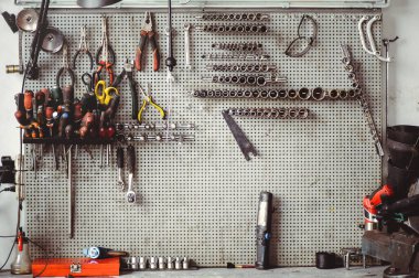 Locksmith's table with keys and tools for the repair of mechanical equipment. Car workshop.