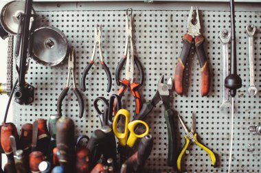 Locksmith's table with keys and tools for the repair of mechanical equipment. Car workshop.