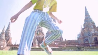 Mutlu Asyalı Çocuk, Tayland 'ın tarihi Ayuthaya harabelerinde tatil ve seyahat konsepti için özgürce zıplıyor..