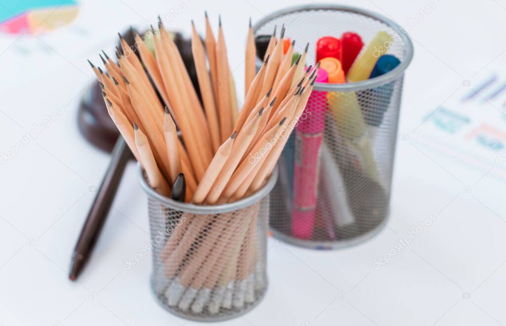 Office stationaries with color pan and pencils on office table.