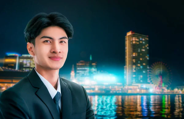 Confidence businessman portrait with Modern Japan nightlight City Background.