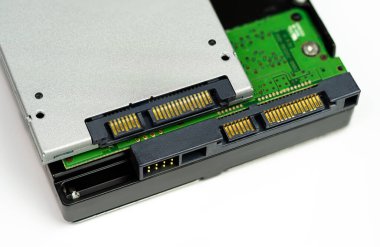 An internal Hardisk drive in 3.5 and SSD drive isolated on white closed up on the SATA connection.