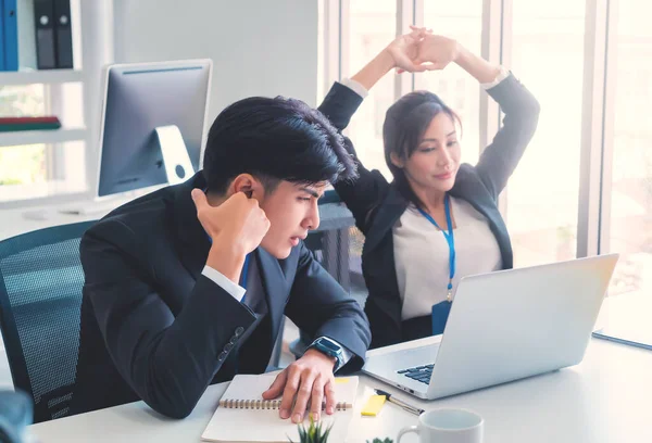 Two disappointed Business person is looking at computer screen with upset and tired faces for business failure concept.