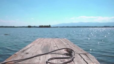 Small wooden boat head traveling in an open water.
