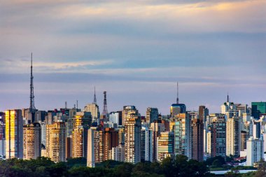 Brezilya 'nın Sao Paulo şehrinde alacakaranlıkta binalar, kuleler ve iletişim antenleri duvarı