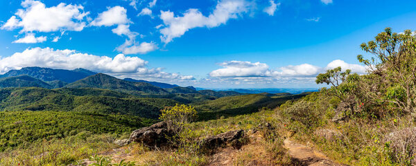 Panoramic image of the mountain ranges with their rocks and vegetation and typical forests of the state of Minas Gerais in Brazil on a sunny day