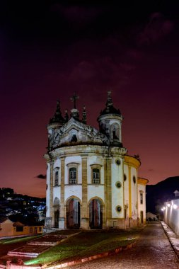 Old baroque church illuminated at dusk in the historic town of Ouro Preto in Minas Gerais