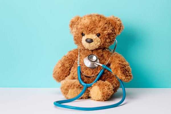 Pediatrics. Teddy bear with a stethoscope. Teddy bear on a green background