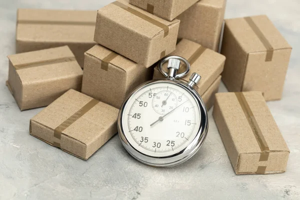 Stopwatch and cardboard boxes. Fast delivery concept — Stock Photo, Image