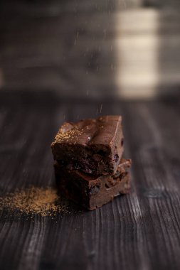 Kekin üzerine koyu bir arka planda kakao serpilmiş.