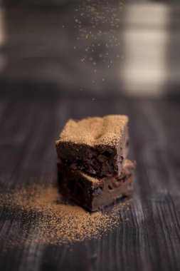 Kekin üzerine koyu bir arka planda kakao serpilmiş.