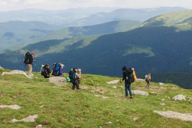 08.07.2021 Ukrayna, Karpatlar - Sırt çantalı bir grup yürüyüşçü dağlarda yürüyor. Özgürlük, seyahat kavramı