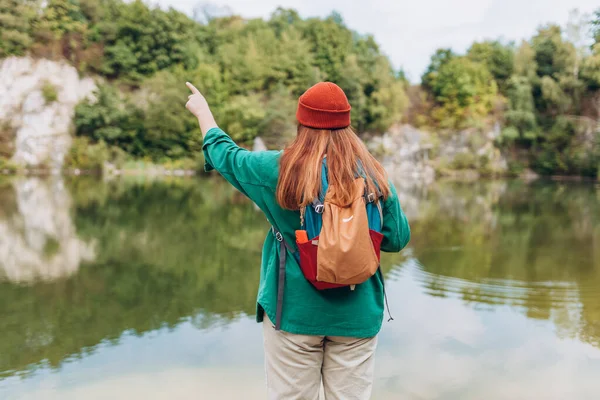 Woman hiking in woods. Adventure women enjoying view of majestic mountain lake explore travel. Freedom and active lifestyle concept. Chill moment