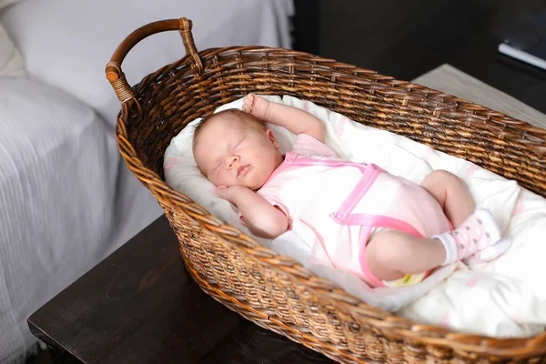 # Caucasian baby girl sleeping in wicker basket in studio #. Stok Foto Bebas Royalti
