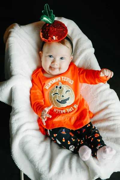 赤ちゃんでハロウィンカボチャの衣装に座って赤ちゃんロッキングチェア笑顔 — ストック写真